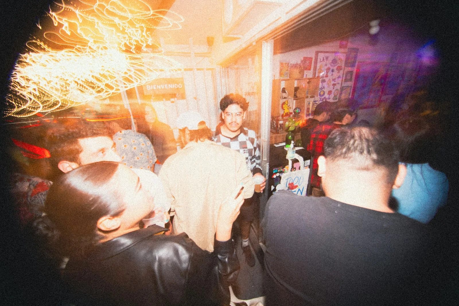 People gathered in a crowded, dimly lit room. People gathered in a crowded, dimly lit room.